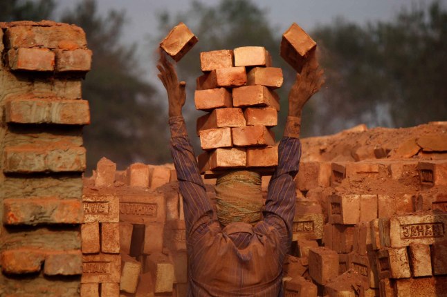 ''Brick Worker'' by Moksumul Haque, Bangladesh. Regional Winner, South Asia. A private enterprise worker is working at a brick field. Small businesses create new jobs for many poor people.