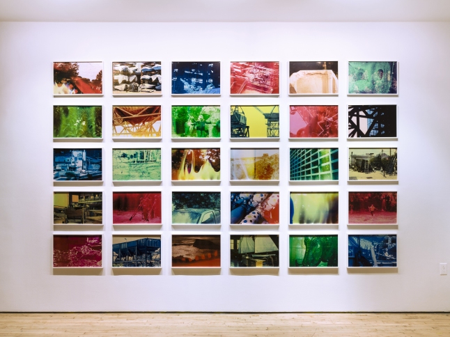Basim Magdy (Egyptian, born 1977). The Hollow Desire to Populate Imaginary Cities. 2014. Installation view Art in General, New York. 30 chromogenic color prints from chemically altered slides on metallic paper, each 13 3/8 × 20 1/16″ (34 × 51 cm). Photo: Charles Benton. Commissioned by Art in General, New York and HOME, Manchester, U.K. ©2015 Basim Magdy